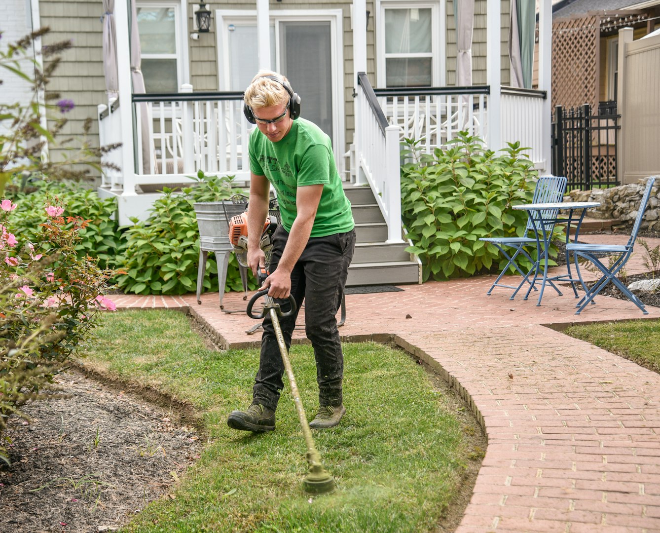 two poeple with black shirts on in a garden working